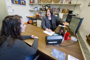 Female department of sociology student in an advising session with a female academic advisor.