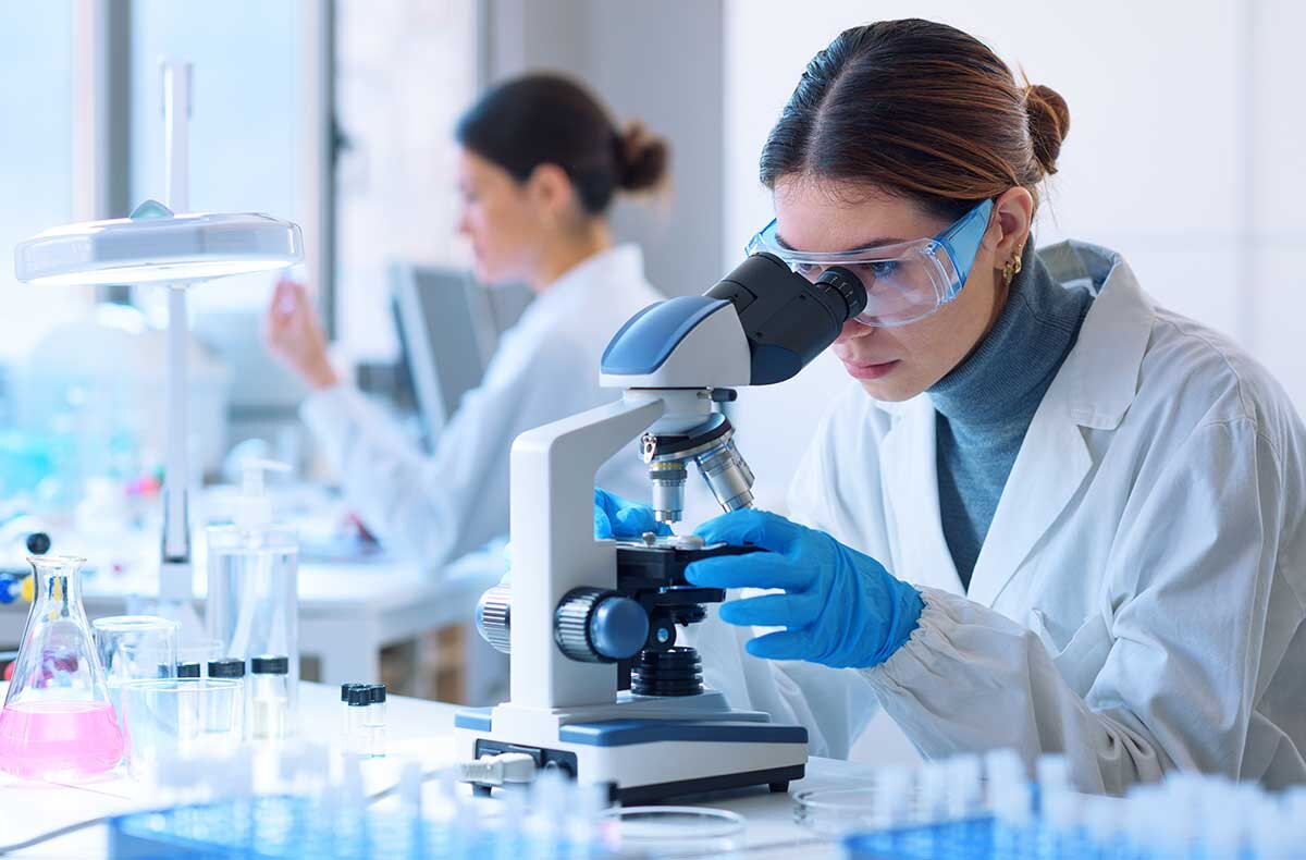Lab workers with microscopes