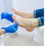 shot of a Podiatrist looking at feet