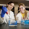 Female students work together in a laboratory.