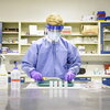 Male undergraduate working in lab using PPE