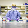 Male undergraduate working in lab using PPE