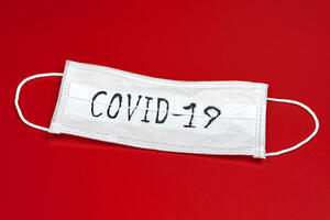 COVID-19 face mask on red background