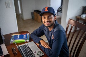 Student in Illinois hat working on his computer