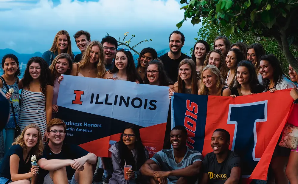 Illini Student in Brazil holding Illinois banners