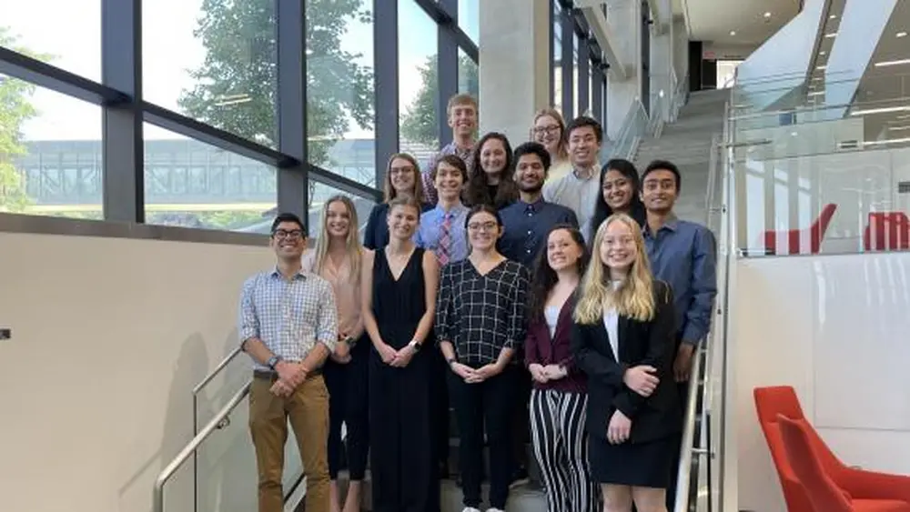 REU students with a group picture on a staircase