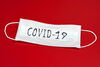 COVID-19 face mask on red background