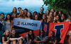 Illini Student in Brazil holding Illinois banners