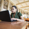Student studying in library on laptop