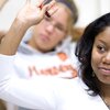 close-up of female student with hand raised in class at the University of Illinois at Urbana-Champaign